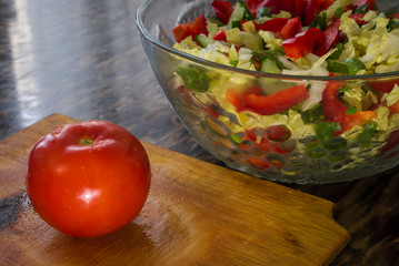 red tomato lie on a Board for a salad