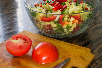 halves of red tomato lying on the cutting Board