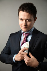 Сorrupt politician in suit takes bribe.