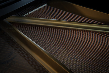 Harp and strings of a grand piano close up