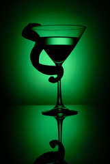 Silhouette wineglass with lime twisted taken in the studio with a spot light grid.