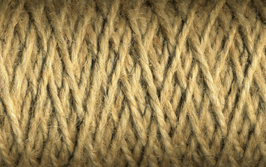 Natural jute twine roll, skein of jute thread texture. micro shot of a coil of jute twine. Supplies and tools for handmade hobby leisure closeup.