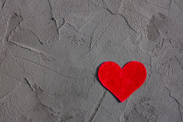 Red paper heart on gray wall with copy space Happy Valentine background