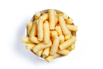 Crunchy corn puffs, pufuleti on bowl isolated over white