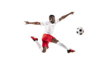 Professional african american football soccer player in motion isolated on white studio background. Fit jumping man in action, jump, movement at game.