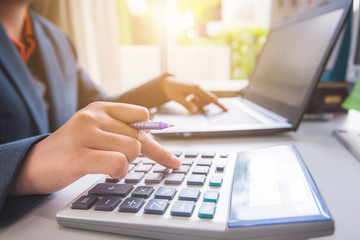 Business woman working with financial report and laptop in work at office 