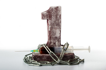syringe with red liquid tied with chain to number one on white background