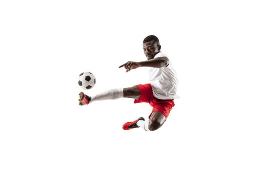 Professional african american football soccer player in motion isolated on white studio background. Fit jumping man in action, jump, movement at game.