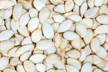  Unpeeled pumpkin seeds    pattern. Macro background texture of white pumpkin seeds