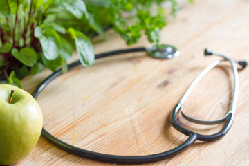 Stethoscope and herbs  healthy life style and alternative medicine background concept