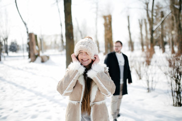 Young Beautiful Couple Taking Fun and Smiling Outdoors in Snowy Winter