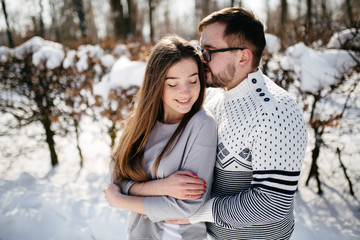 Fototapeta premium Young Beautiful Couple Taking Fun and Smiling Outdoors in Snowy Winter