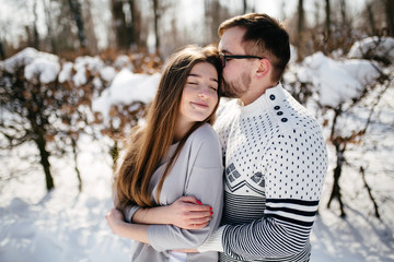 Young Beautiful Couple Taking Fun and Smiling Outdoors in Snowy Winter