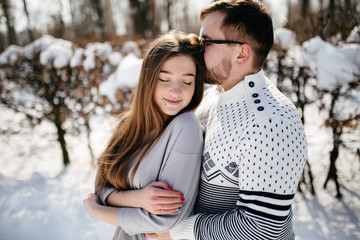 Fototapeta premium Young Beautiful Couple Taking Fun and Smiling Outdoors in Snowy Winter