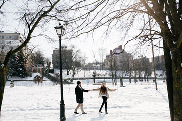 Young Beautiful Couple Taking Fun and Smiling Outdoors in Snowy Winter