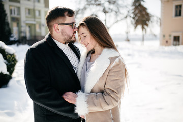 Young Beautiful Couple Taking Fun and Smiling Outdoors in Snowy Winter