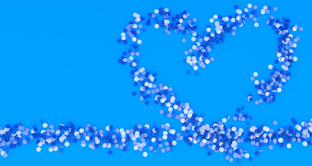 many blue pills poured in the shape of a heart on a blue background, 3d illustration
