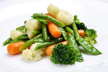 Poster Steamed vegetables on white background. Cauliflower, peas, broccoli, carrots and asparagus beans. © GrumJum