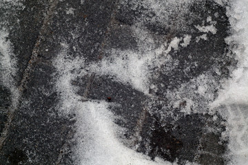 Snow on pavement.