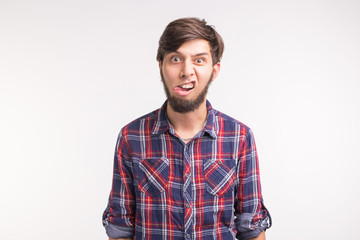 Fototapeta premium Expression, april fools day and joke concept - Young funny bearded man sticks his tongue out