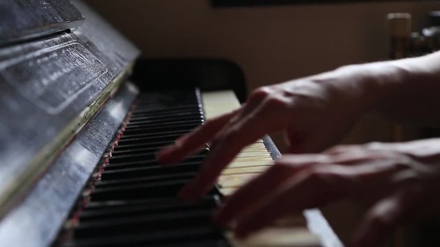 Close up fingers of woman pianist at the rusty piano keys, arms plays solo of music. Hands of female musician playing. Music instrument, solo pianist, song composer, hobby, practice study.