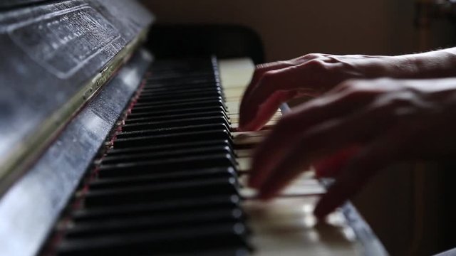Close up fingers of woman pianist at the rusty piano keys, arms plays solo of music. Hands of female musician playing. Music instrument, solo pianist, song composer, hobby, practice study.