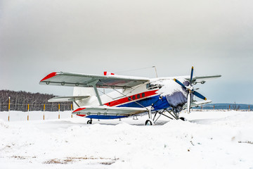 Small plane landed at the airport in winter.
