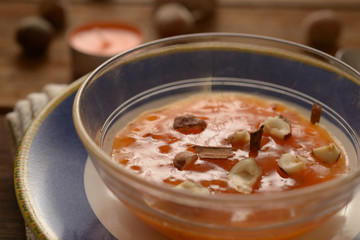 persimmon smoothied in cup with dried fruit an cinnamon
