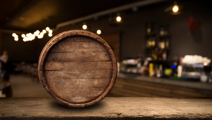 Beer barrel with beer glasses on a wooden table. The dark brown background.
