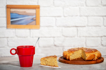 red cup of coffee with handmade sponge cake