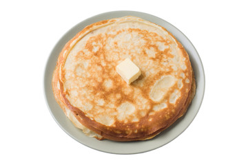 Thin pancakes on a plate isolated on a white background.