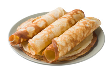 Thin pancakes on a plate isolated on a white background.
