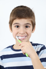 Tooth Care-Boy Brushing His Teeth With Toothbrush White Background