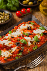 Cod in Italian in tomatoes with olives and capers.
