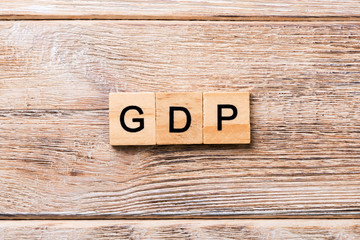 GDP word written on wood block. GDP text on wooden table for your desing, concept