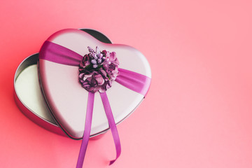 Heart-shaped gift box decorated with flower and ribbons