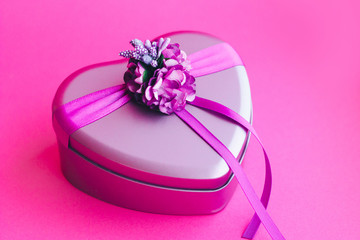 Heart-shaped gift box decorated with flower and ribbons