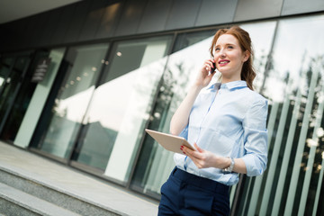 Portrait of pretty student or businesswoman in smart casual using digital tablet