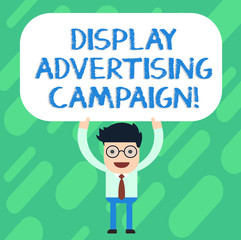 Handwriting text Display Advertising Campaign. Concept meaning conveys a commercial message using graphics Man Standing Holding Above his Head Blank Rectangular Colored Board