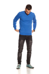 Naklejka premium handsome young man in blouse and jeans on white background