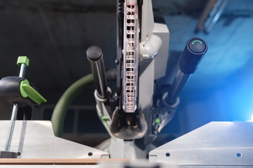 Close-up manual saw blade circular saw with plastic protection on the slides for cutting wood in the home workshop