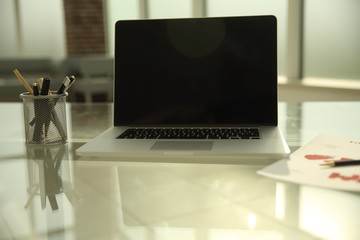 close up. open laptop on glass table.