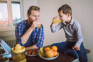 Fototapeta na wymiar Father and son having healthy breakfast together