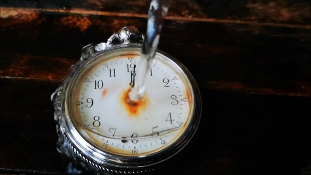 the water flows on the broken vintage pocket watches
