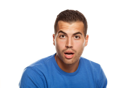 portrait of surprised young man on white background