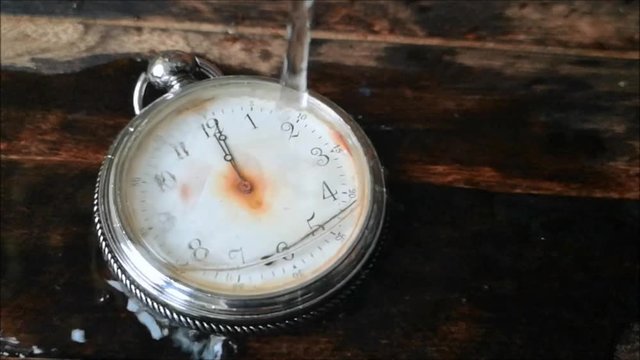 the water flows on the broken vintage pocket watches
