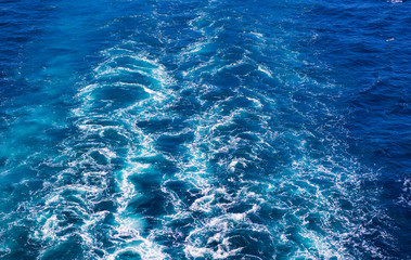 Cruise ship wake or trail on ocean surface, white trace