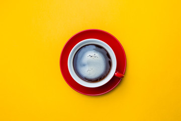 Top view image of coffe cup on yellow background. Flat lay. Copy space