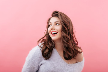 Cheerful plus size model looking away