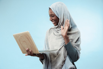 Portrait Of Female University Student Working on laptop. The beautiful young black african muslim...